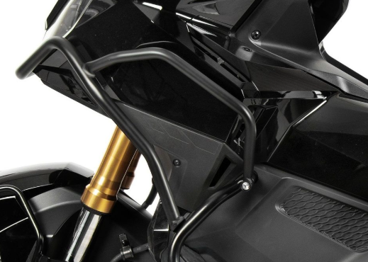 Close-up of a motorcycle with a gold exhaust pipe on a white background