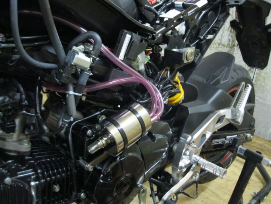 Close-up of a motorcycle engine with visible wiring and components.