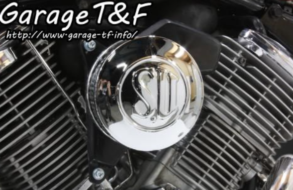 Motorcycle engine cover with brand logo and 'Garage T&F' text.