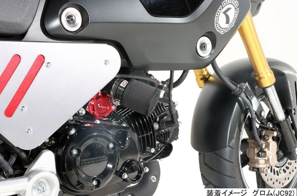 Close-up of a motorcycle engine with visible branding on a white background