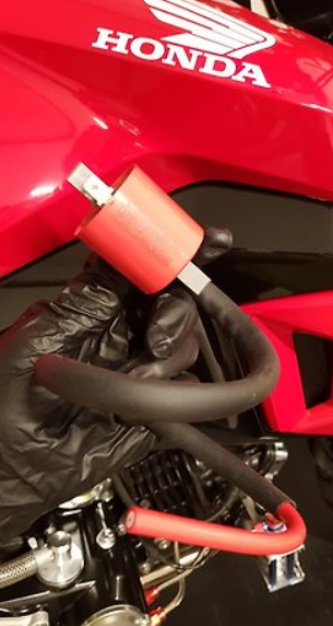 Red Honda motorcycle with a red lock on a black background