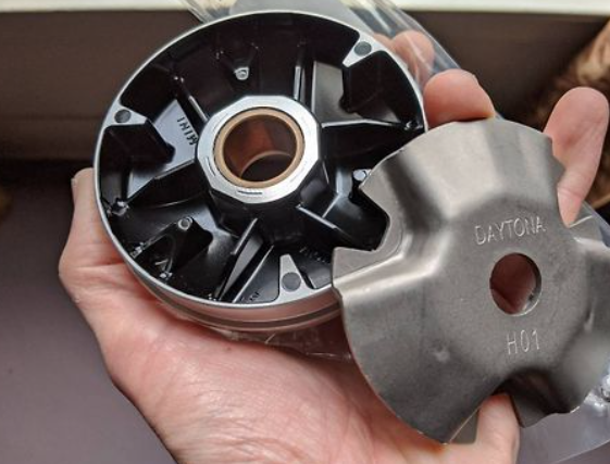 Hand holding two metal components with 'Daytona' branding.