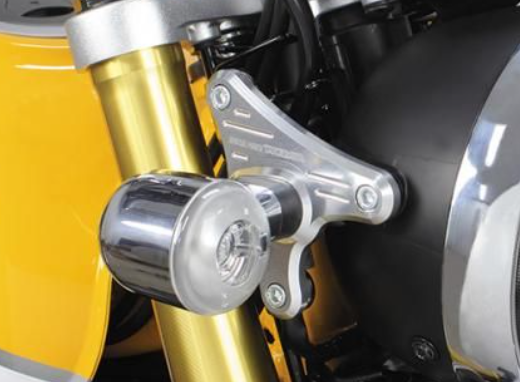 Close-up of a motorcycle's suspension system with gold and black components.