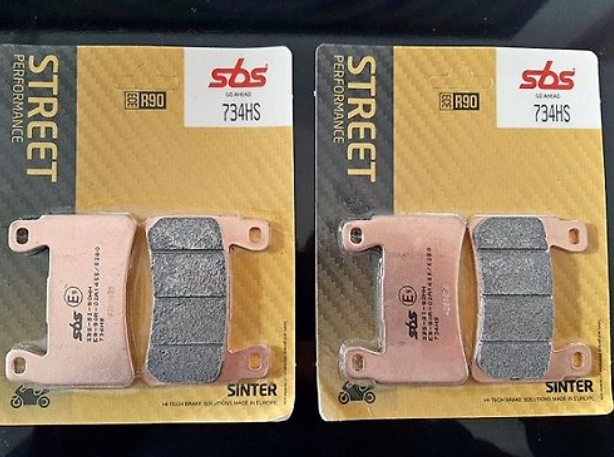 Two packages of SBS Street Performance brake pads on a dark background