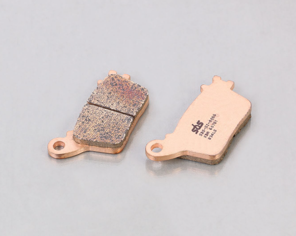 Two brake pads on a gray background