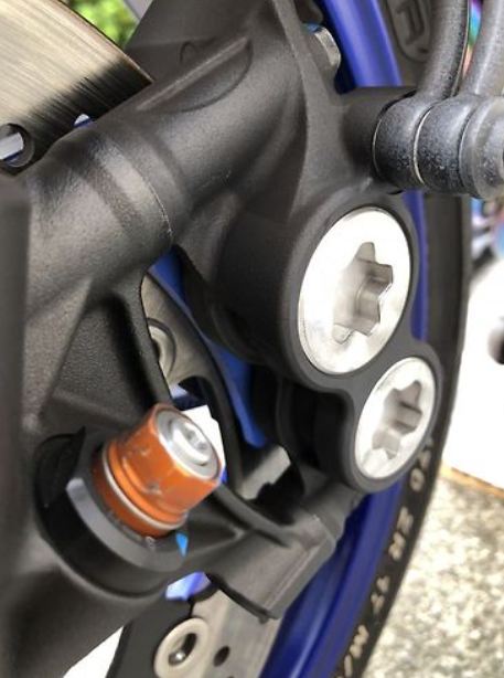 Close-up of a motorcycle's suspension system with visible components.