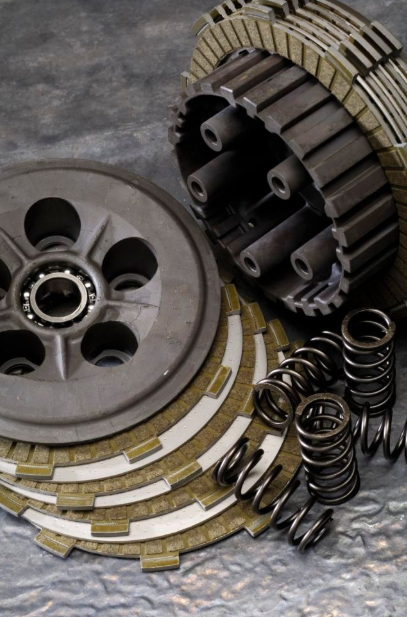 Clutch plates, springs, and pressure plate on a gray background