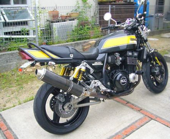 Motorcycle with black and yellow design parked on a concrete surface.
