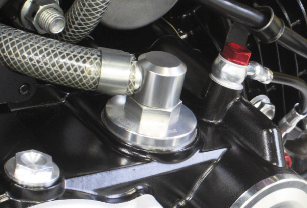 Close-up of a motorcycle engine with various components.