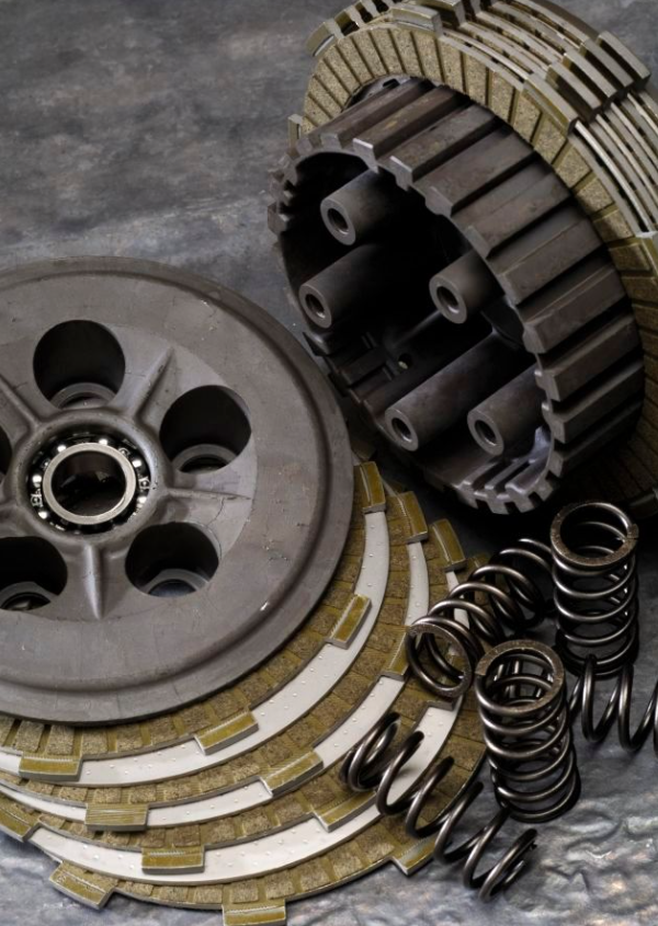 Clutch plates, springs, and pressure plate on a gray background