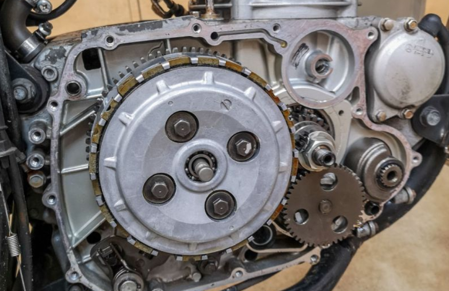 Close-up of a mechanical engine component with gears and metal parts.