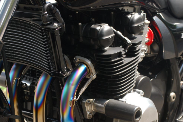 Close-up of a motorcycle engine with colorful pipes