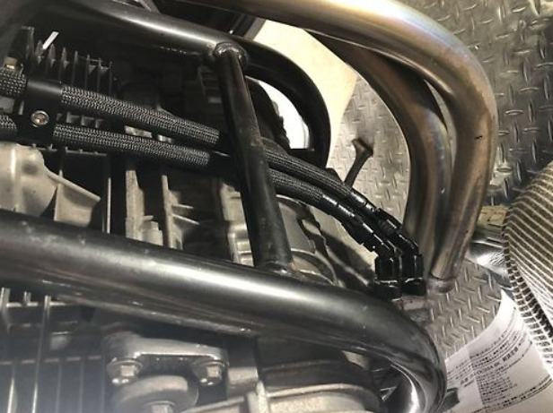 Close-up of a motorcycle's exhaust system and engine components.