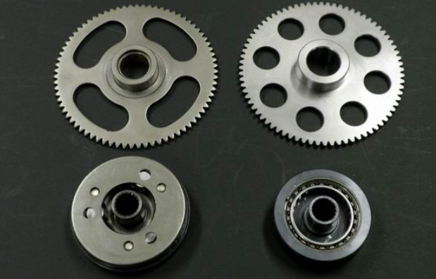 Four metal gears on a dark background