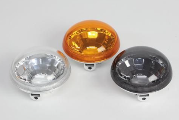 Three different colored vehicle lights on a white background