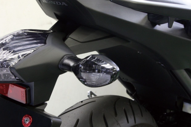 Close-up of a motorcycle with visible Honda branding on the back