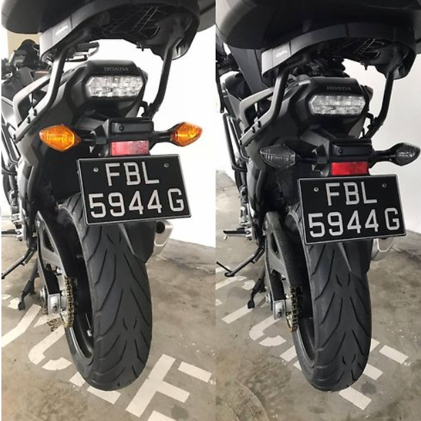 Two views of a motorcycle with a license plate 'FBL 5944G' on a concrete surface.