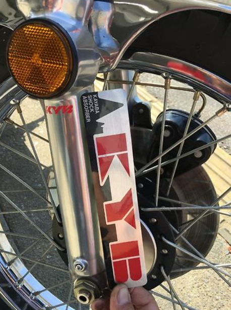 Close-up of a motorcycle wheel with a KYB shock absorber