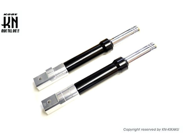 Two shock absorbers on a white background with KOKI branding.