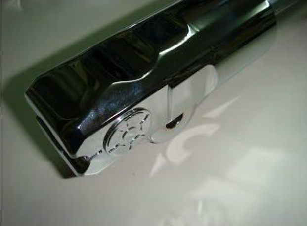 Chrome handle on a white surface