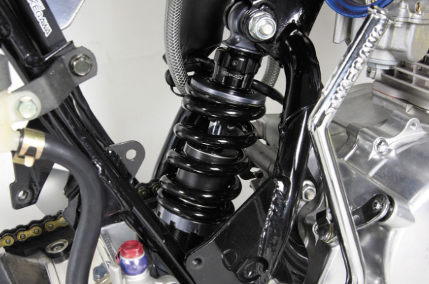 Close-up of a motorcycle suspension system with visible branding.