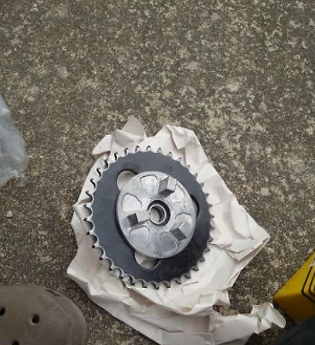 Mechanical gear on a piece of paper with a concrete floor background