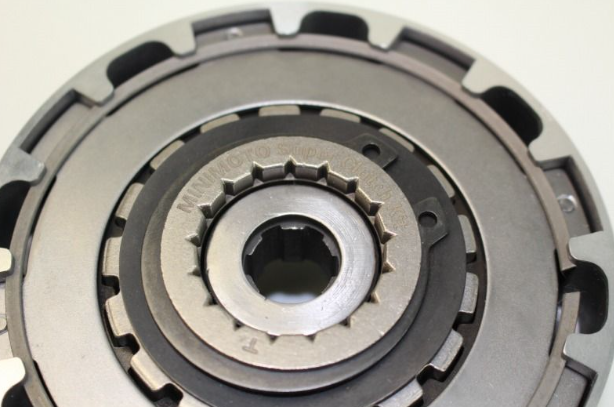 Close-up of a mechanical clutch disc on a white background