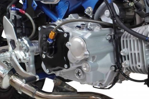 Close-up of a motorcycle engine with visible components on a white background