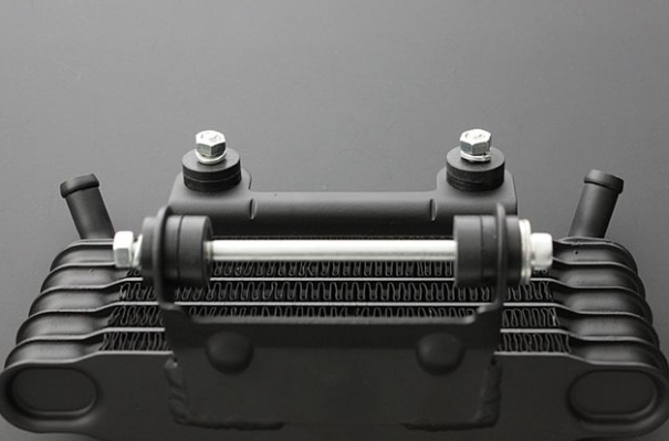 Black metal heat exchanger on a gray background