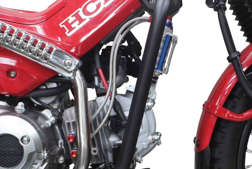 Close-up of a red motorcycle engine with visible 'Honda' branding.