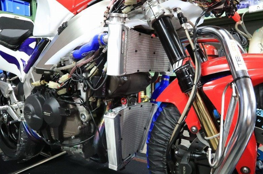 Close-up of a motorcycle engine and components with visible branding.