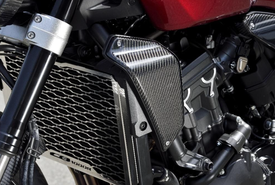 Close-up of a motorcycle engine with carbon fiber cover