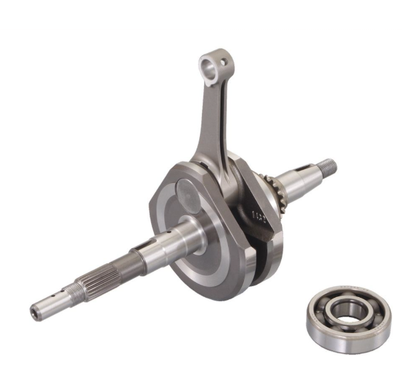 Metallic crankshaft with a bearing on a white background