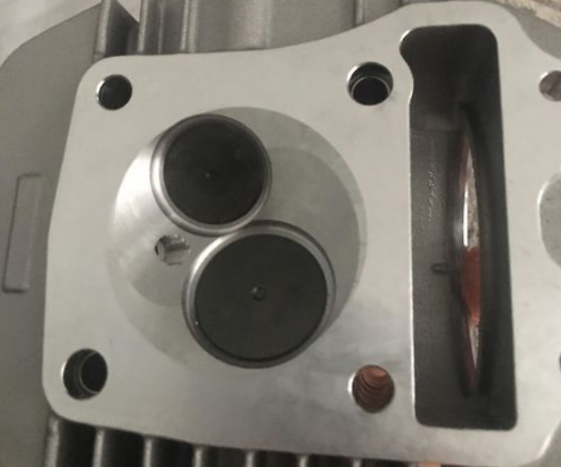 Metal mechanical component with cylindrical holes on a metallic background