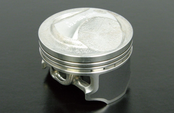 Metallic piston on a dark background