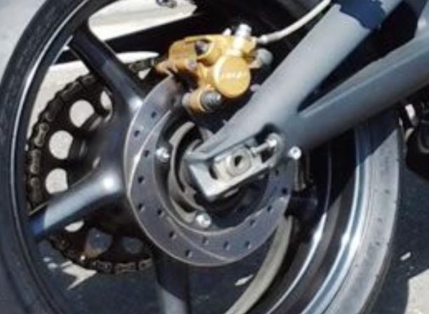 Close-up of a motorcycle wheel with brake components
