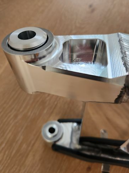 Metallic elbow fitting on a wooden surface