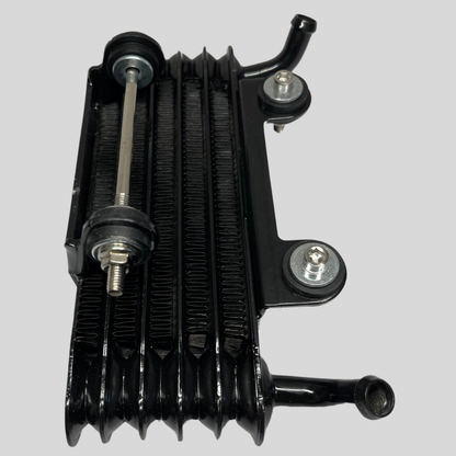 Side view of Z2 Kawasaki OEM Oil Cooler showing mounting hardware and intact cooling fins. Fits Z1, Z2, KZ900, KZ1000, and other classic models.