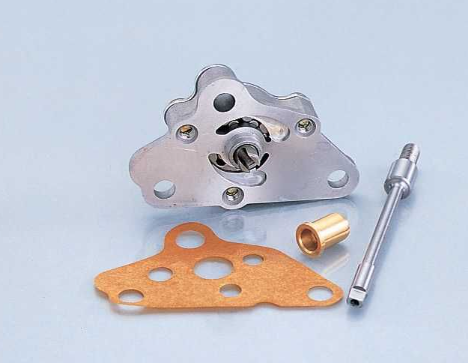 Mechanical parts including a metal plate, gasket, and cylindrical component on a light blue background