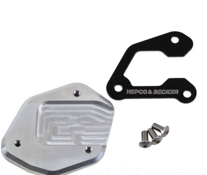 Metallic engine cover with screws and 'Herco & Becker' branding on a white background