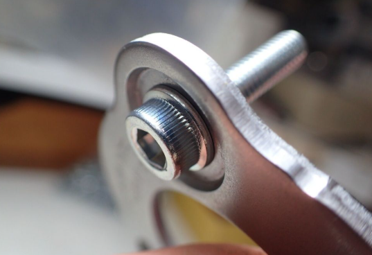 Close-up of a metal screw or bolt with a blurred background