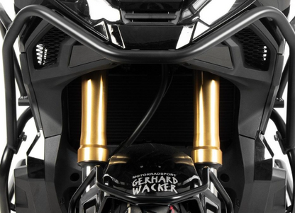Close-up of motorcycle suspension with 'Gerhard Wacker' branding on a white background