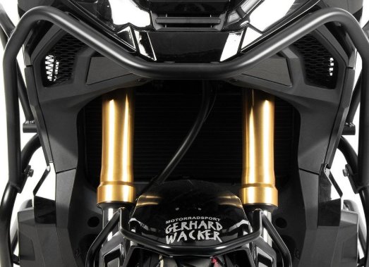 Close-up of motorcycle suspension with 'Gerhard Wacker' branding on a white background
