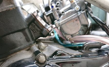 Close-up of motorcycle engine components with visible wiring.