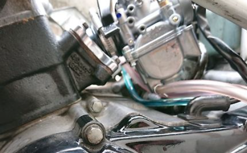 Close-up of motorcycle engine components with visible wiring.