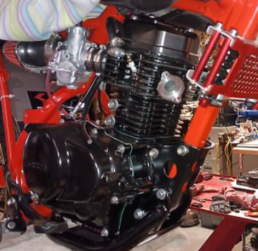 Close-up of a motorcycle engine with red and black details.