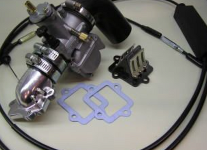 Mechanical parts including a carburetor and gaskets on a white surface