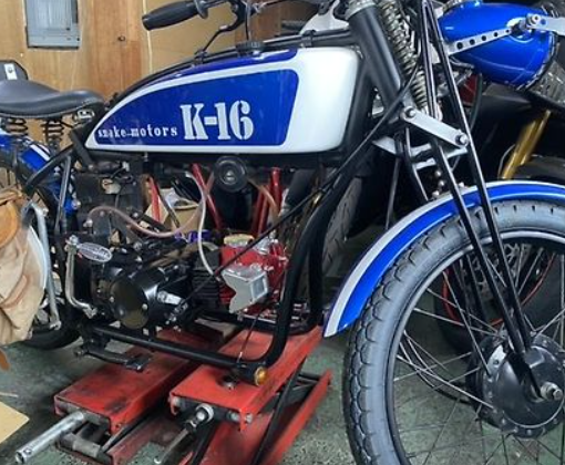 Motorcycle with 'K-16' branding on a lift in a garage setting