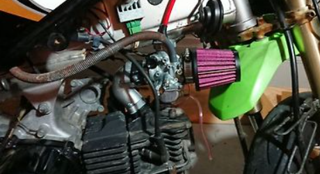 Close-up of a motorcycle engine with a purple air filter.