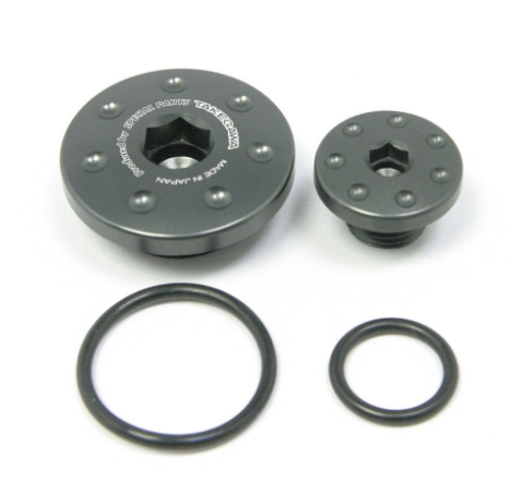 Set of black metal components with o-rings on a white background